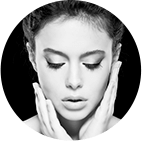Round cropped image of a woman with hands on her face