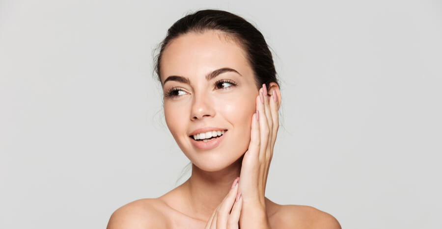 Young woman touching face