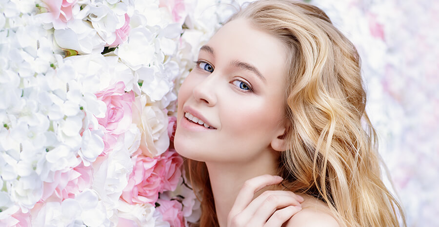 Young woman in bed of flowers